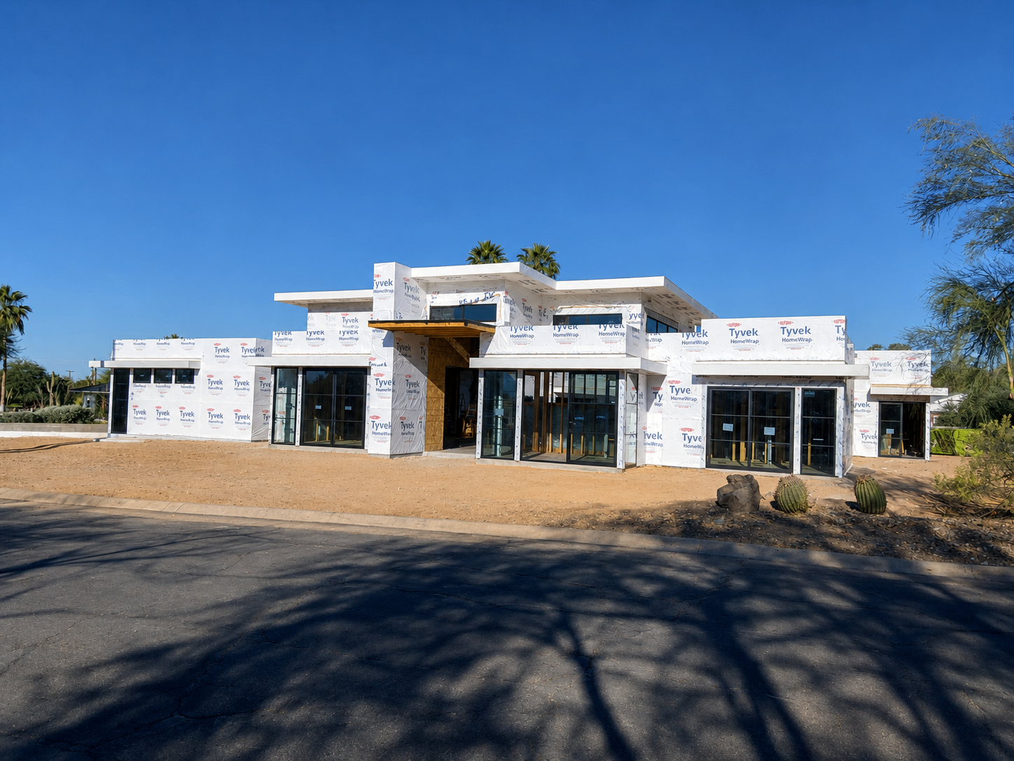 M1, front elevation wrapped in Tyvek with window openings framed