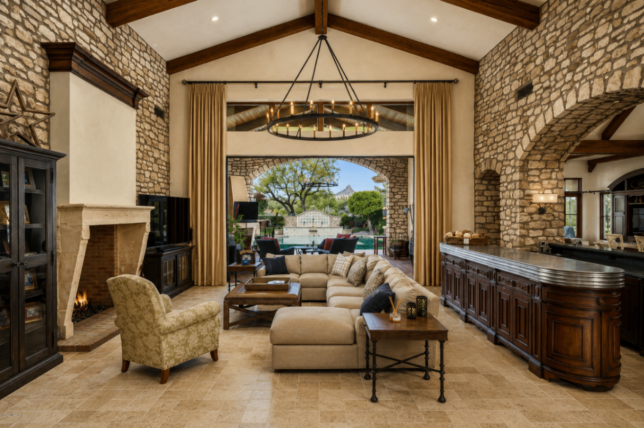 DC Ranch Villa, great room framed by stone walls and chandeliers