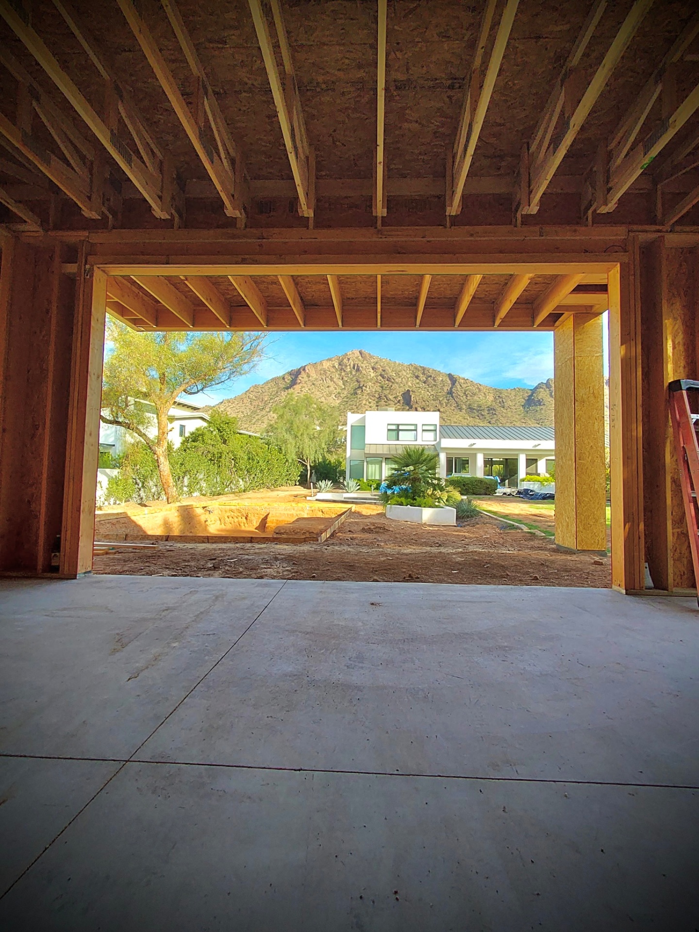 Camello, framed opening looking out to the neighboring home and mountain backdrop