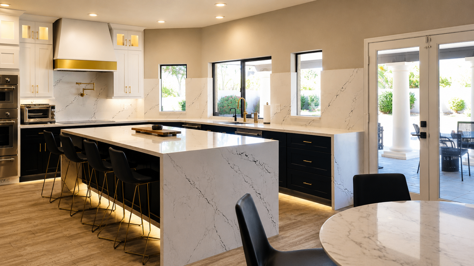 Sutton renovation, open kitchen with waterfall marble island and brass accents
