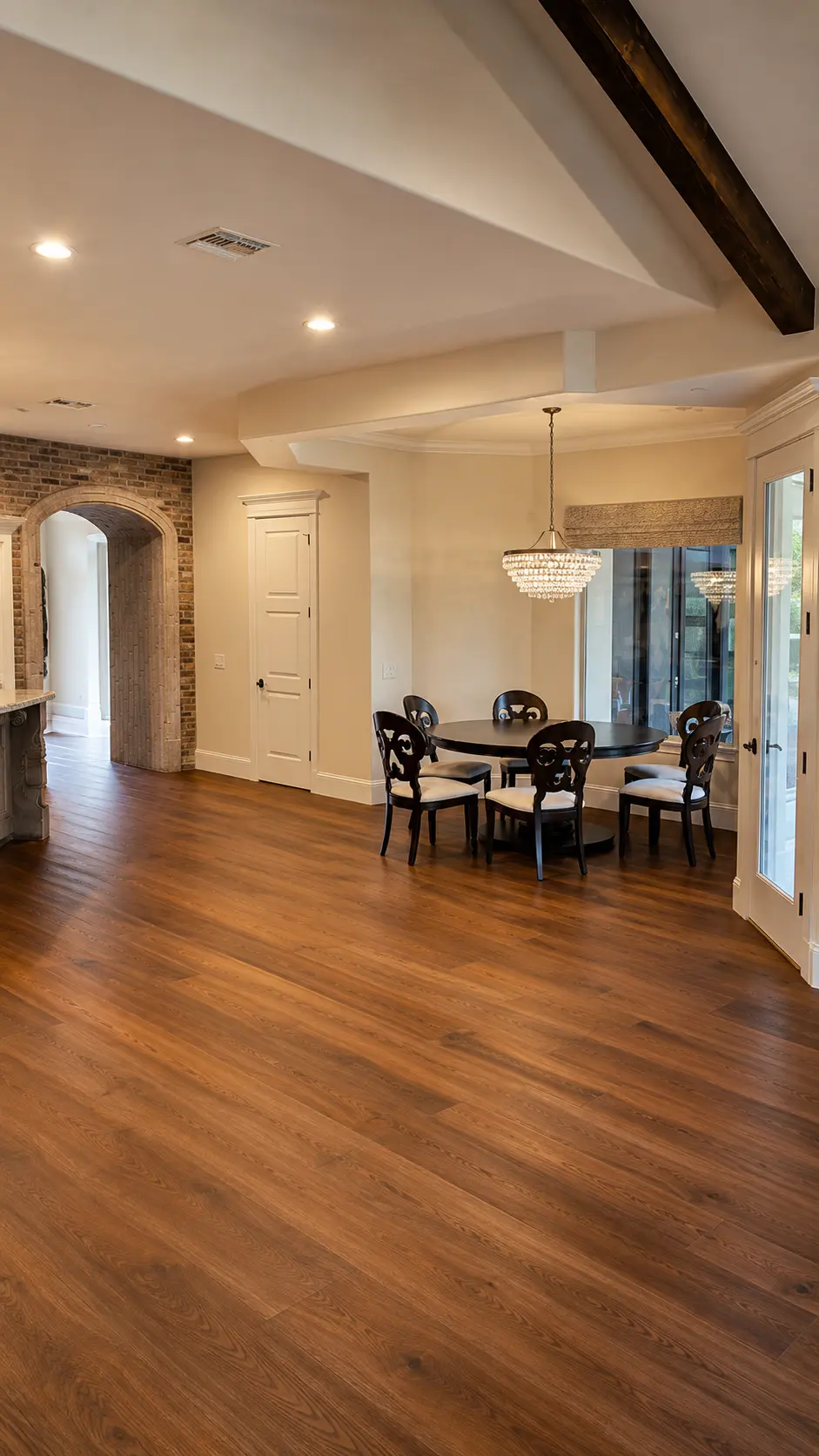 Dartmouth renovation, open living and dining area with brick archway and wood floors