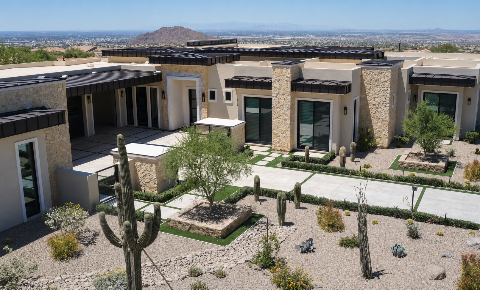 La Senda, front elevation with stone walls, standing-seam roofs, and cactus courtyard