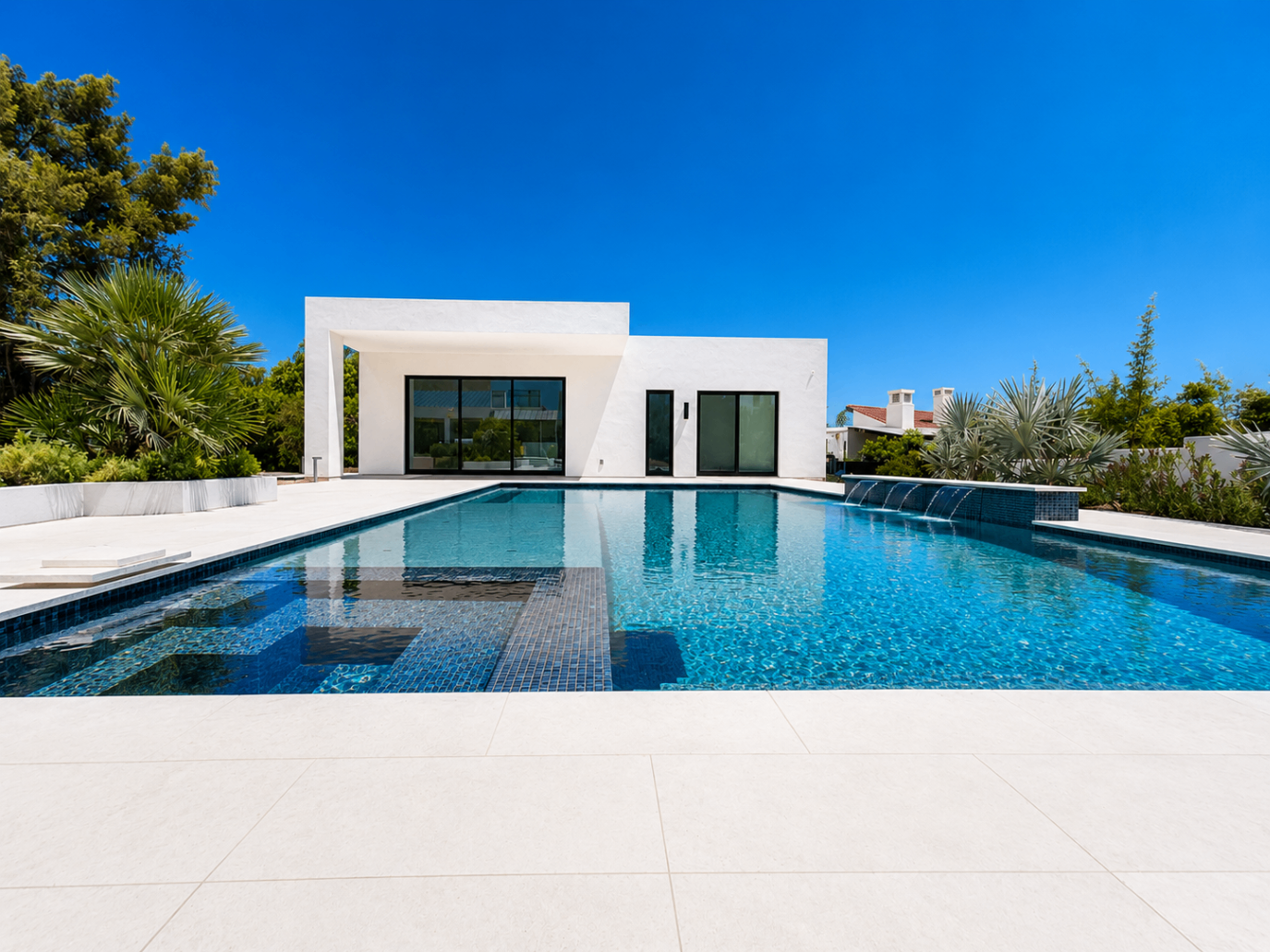 Camello, completed backyard with modern pool and crisp white exterior