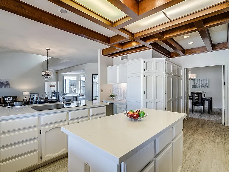 Sutton renovation, before photo of the kitchen island with wood coffered ceiling in background