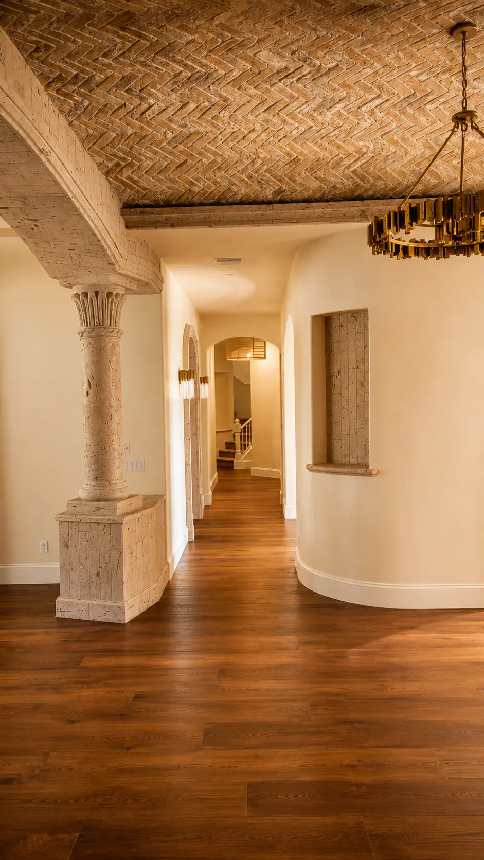 Dartmouth renovation, hallway with carved stone column and herringbone brick vault