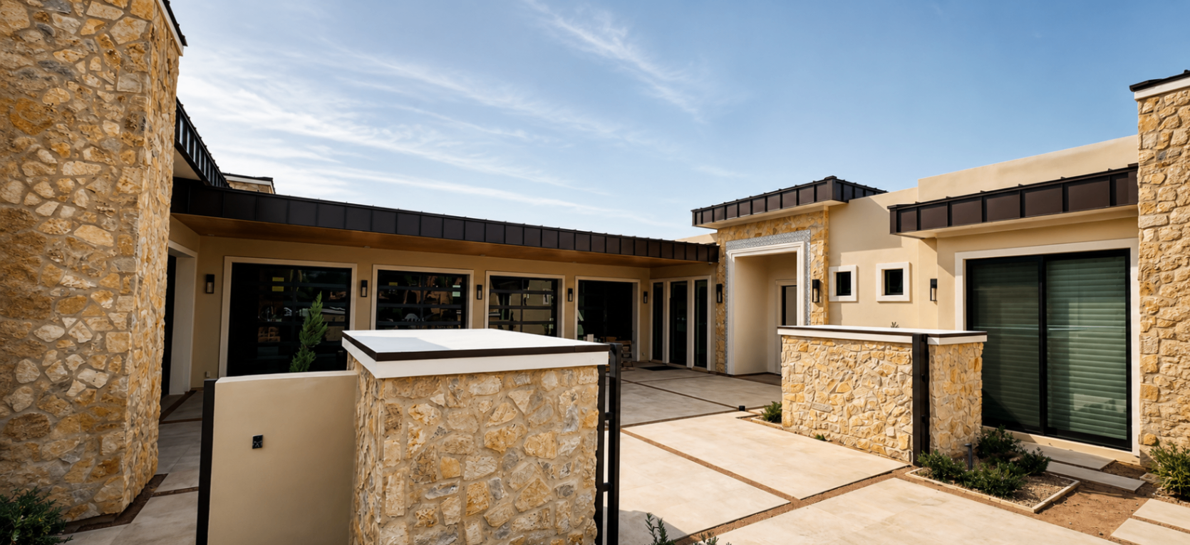 La Senda, entry courtyard with stone walls and modern lines