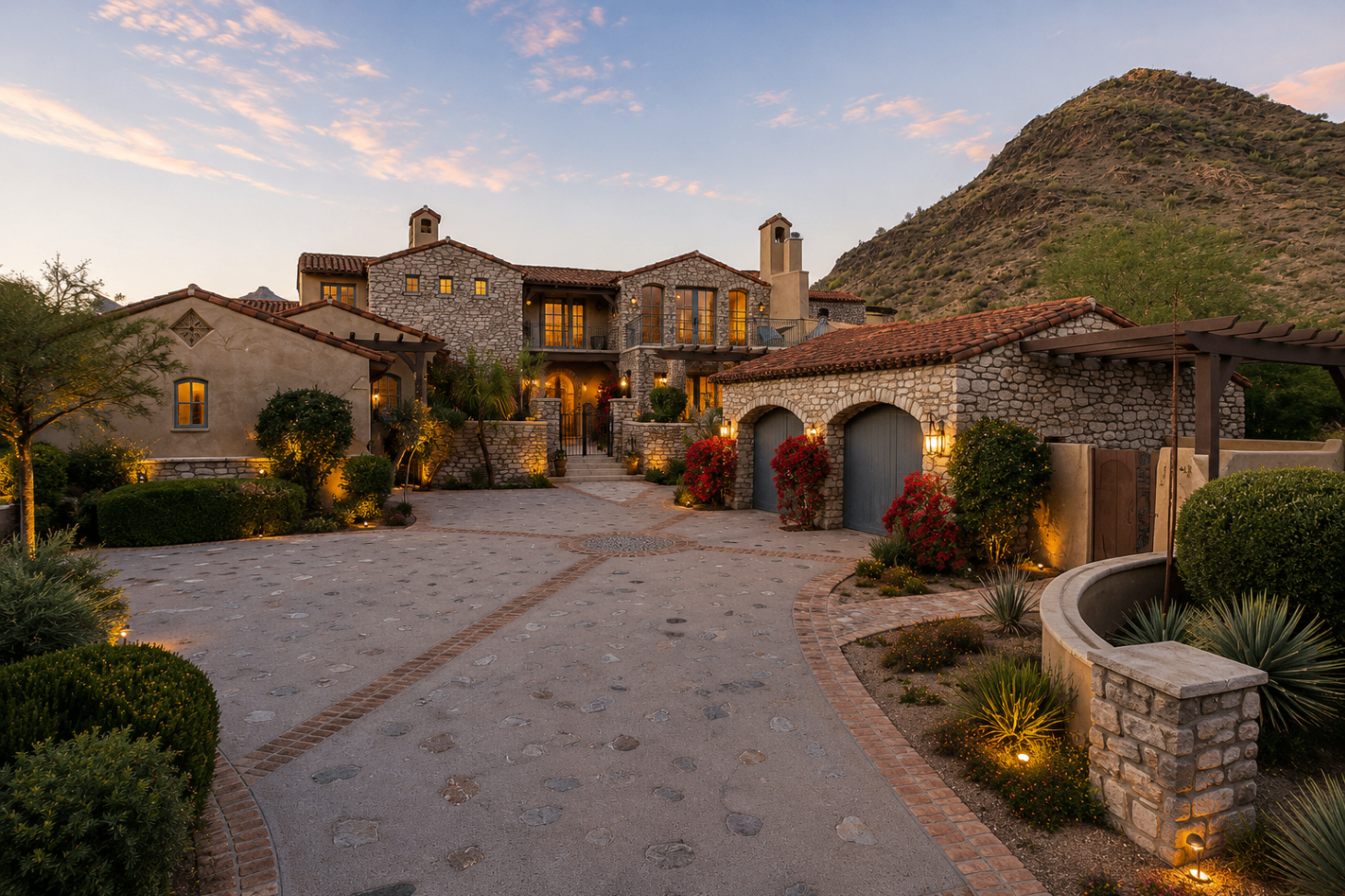 DC Ranch Villa, front elevation at dusk with stone facade and mountain backdrop