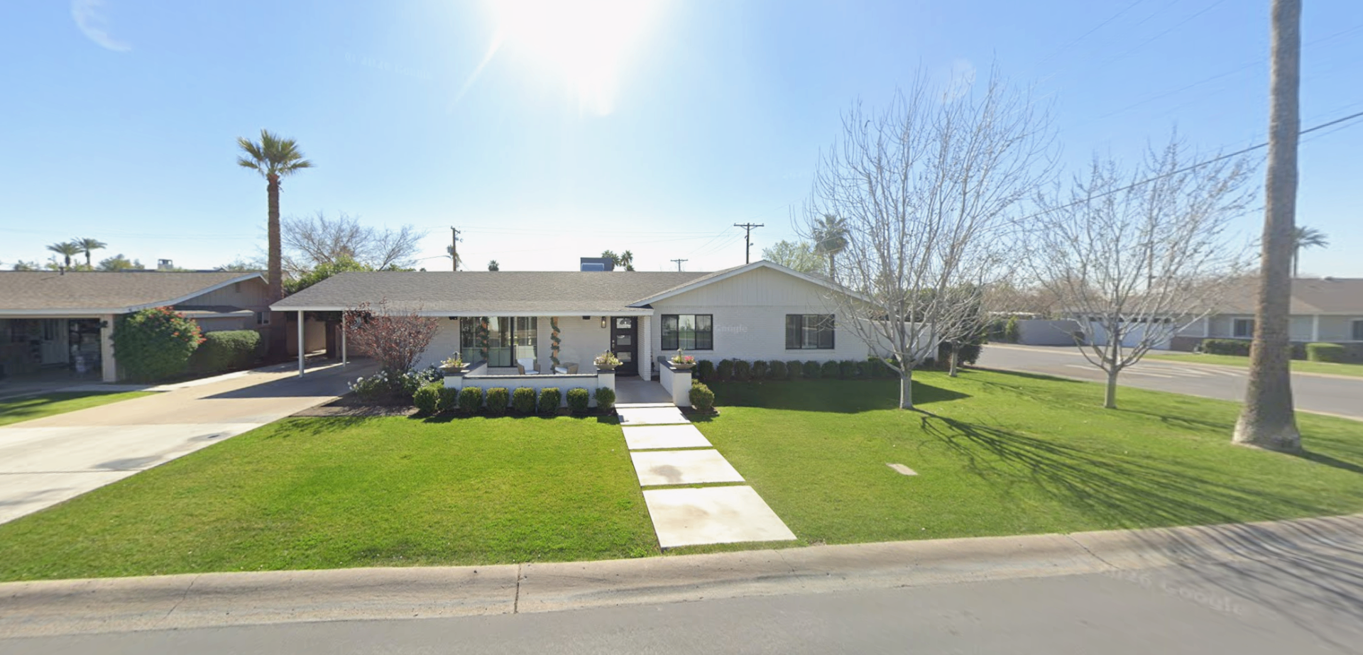 PJ2 current exterior before renovation with wide front lawn and ranch-style facade