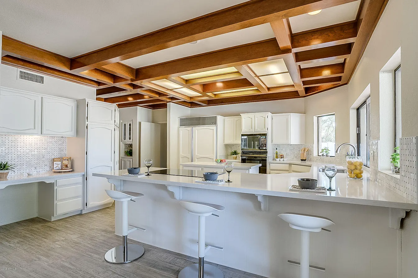 Sutton renovation, before photo of the kitchen with wood coffered ceiling and white cabinetry