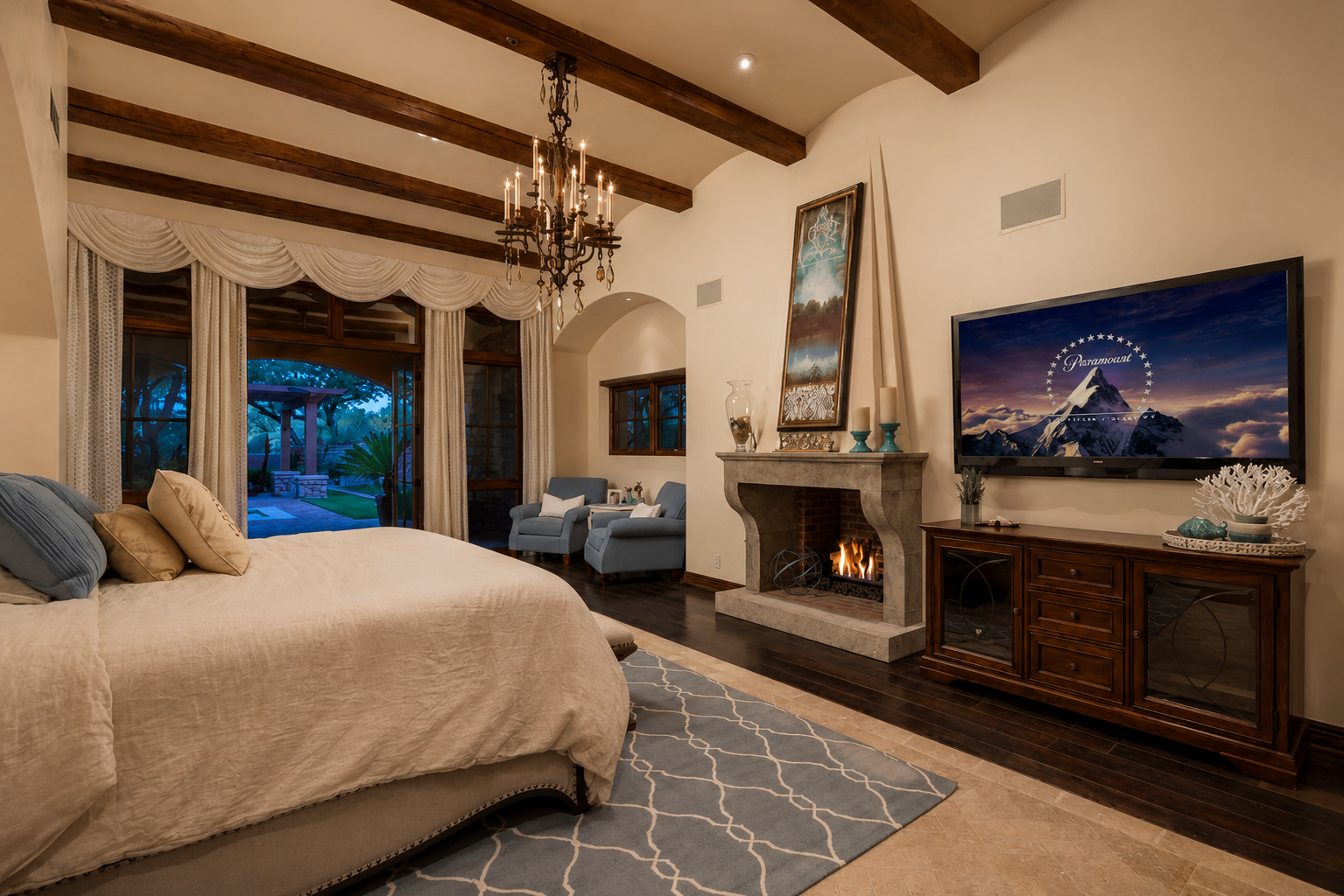 DC Ranch Villa, primary bedroom with wood beams and stone fireplace