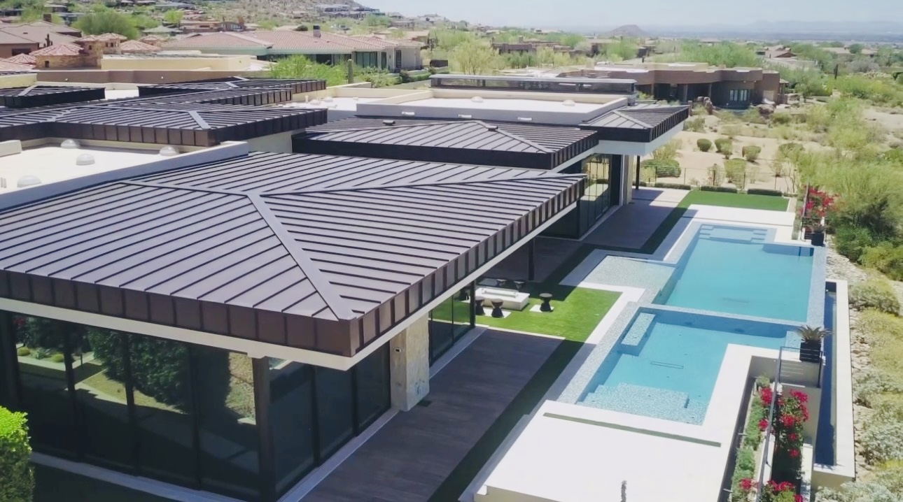 La Senda, aerial view of standing-seam roofs, pool, and desert landscape